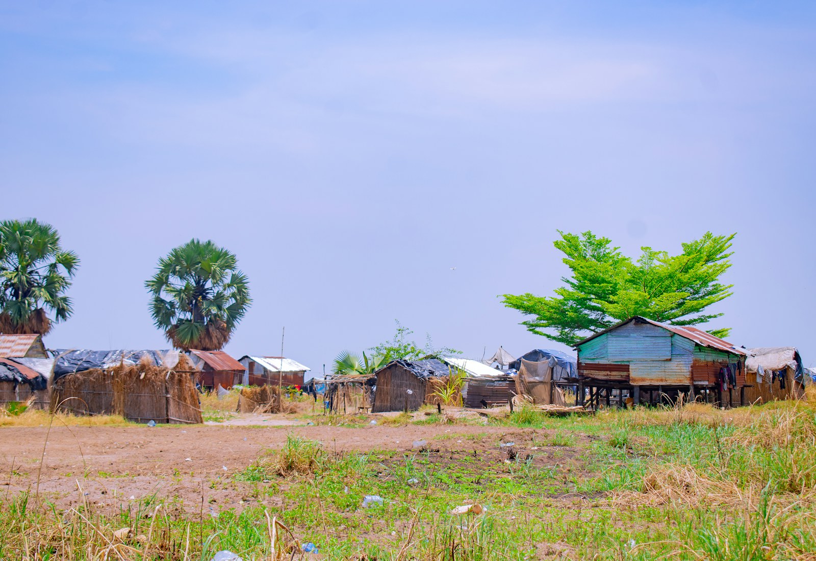 Simple village homes beside an open dirt path