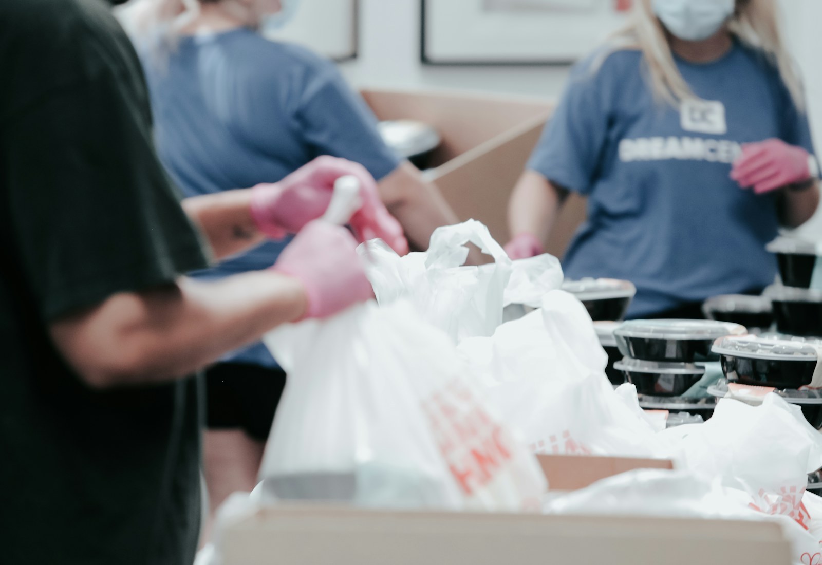 Volunteers packing prepared meals for distribution